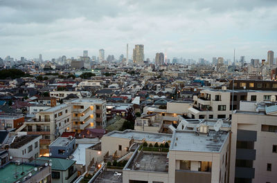 High angle view of cityscape against cloudy sky