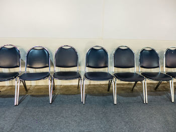 Empty chairs against wall