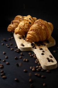 Close-up of bread on table against black background