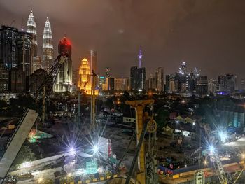 High angle view of illuminated buildings against sky at night