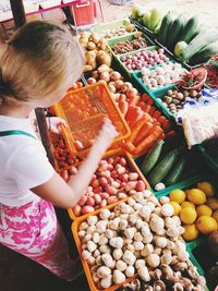 High angle view of woman holding vegetables at market