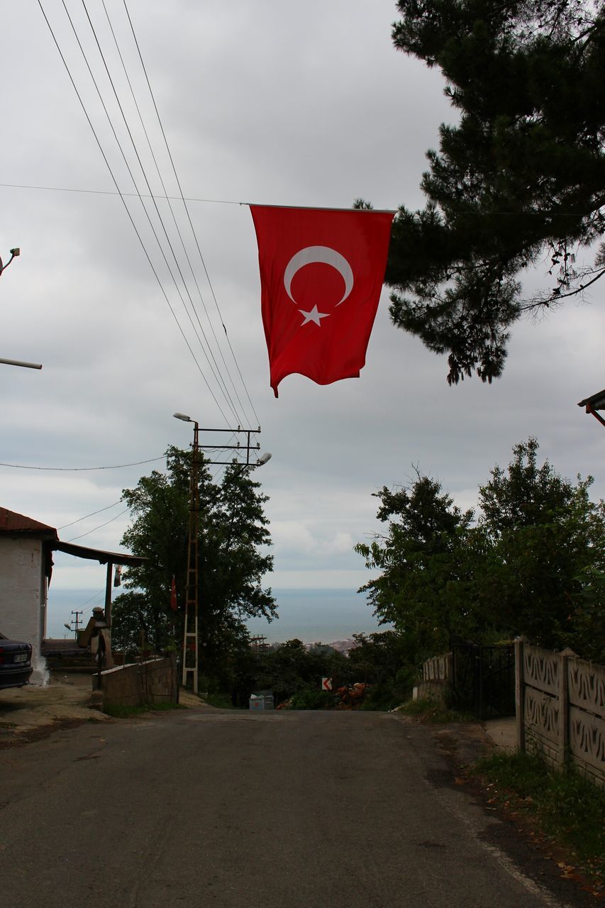 RED FLAG AGAINST SKY IN CITY