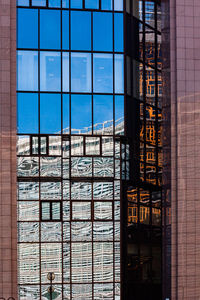 Reflection of building on glass window