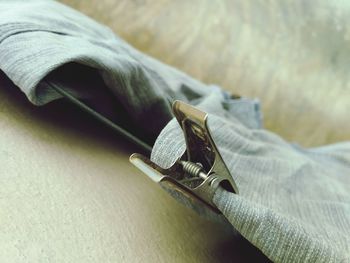 High angle view of jeans hanging on clothesline by wall