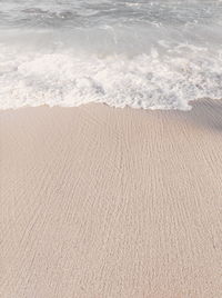 High angle view of waves rushing towards shore