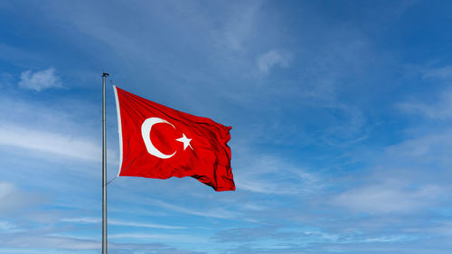 Low angle view of flag against sky