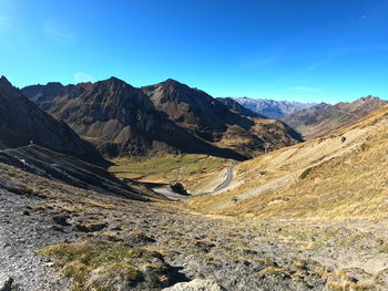 Scenic view of mountains against blue sky