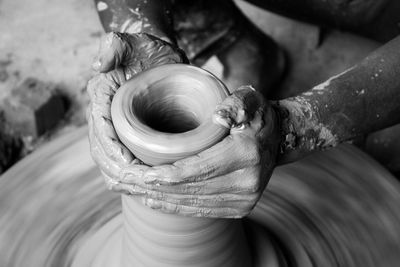 Cropped image of man making pottery