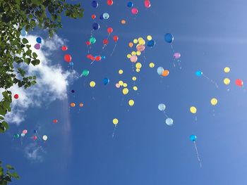 Low angle view of balloons in blue sky