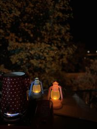 Close-up of illuminated electric lamp on table