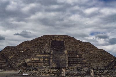 Low angle view of historical building against cloudy sky