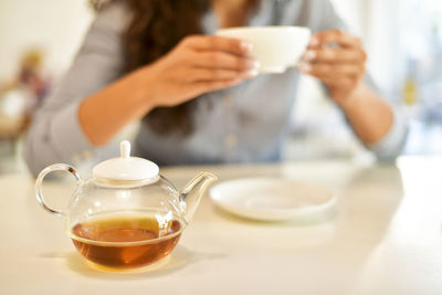 Midsection of coffee cup on table