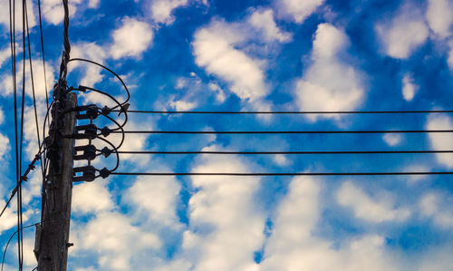 Low angle view of electricity pylon against sky