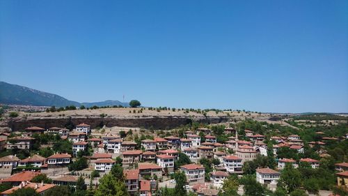 Townscape against clear blue sky