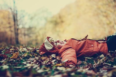 Low section of man lying down on land during autumn