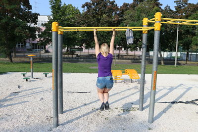 Rear view of girl playing in park