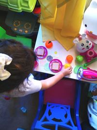 High angle view of girl holding colorful table