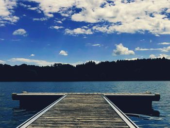 Pier over lake against sky