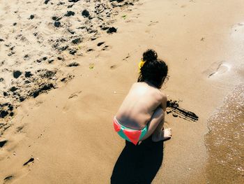 Rear view of woman standing on beach