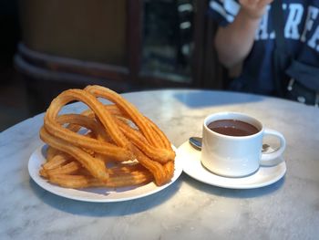 Cup of coffee with cups on table