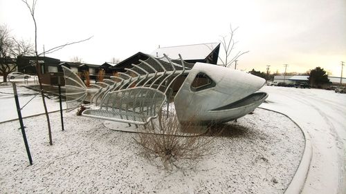 Snow covered built structure against sky