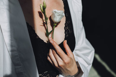 Midsection of couple holding hands