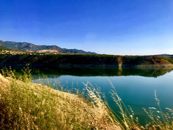 Scenic view of lake against blue sky