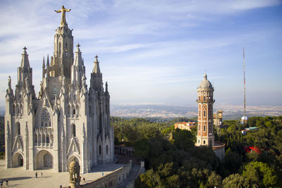 Panoramic view of buildings in city against sky