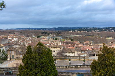 View of townscape against cloudy sky