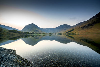 Scenic view of lake and mountains against sky