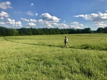 Man playing soccer on field against sky