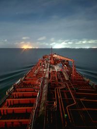 High angle view of a vessel navigating by the sea against sky during the night