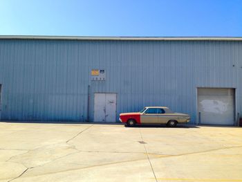 Vintage car against warehouse