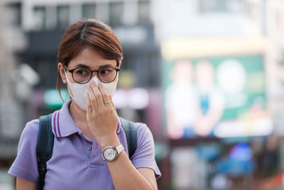 Woman looking away while wearing pollution mask