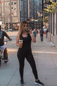 Full length of woman standing on street in city