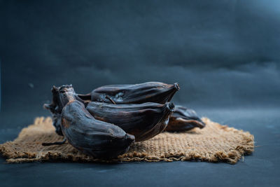 The black rotten banana comb on a sack background