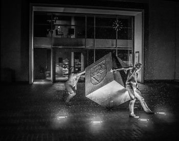 Digital composite image of people on window of building at night