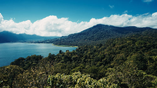 Scenic view of sea and mountains against sky