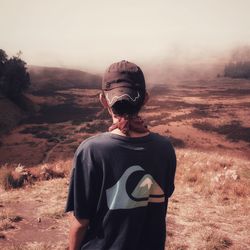 Man standing on field against sky