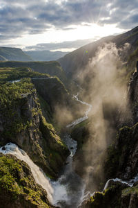 Scenic view of waterfall against sky