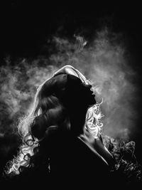 Boudoir showgirl with backlight and smoke black and white