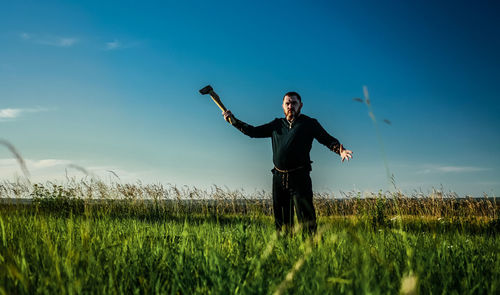 Man standing on field against sky
