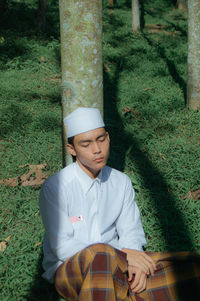 Portrait of young people muslim sitting on field