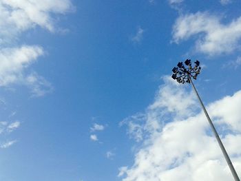 Low angle view of street light against cloudy sky