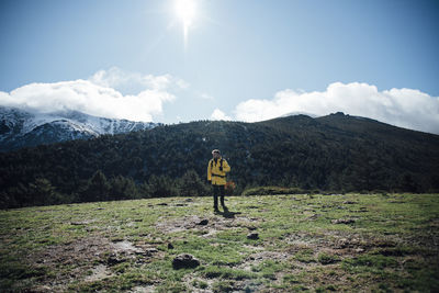 Man standing on mountain against sky