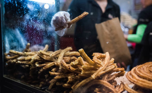 Midsection of man selling food in market