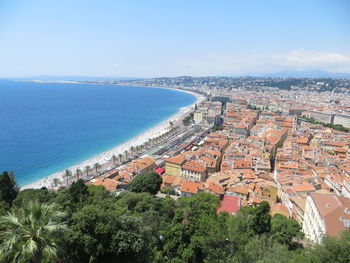 High angle view of townscape by sea against sky