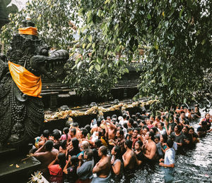 Group of people against plants