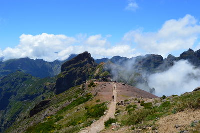 Scenic view of mountains against cloudy sky