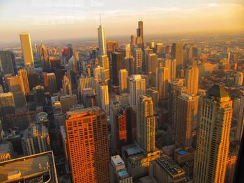 Aerial view of city lit up at sunset